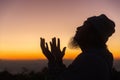 Silhouette of man kneeling down praying for worship God at sky background. Christians pray to jesus christ for calmness. In Royalty Free Stock Photo