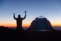 Silhouette of man kneeling down praying for worship God at sky background. Christians pray to jesus christ for calmness. In Royalty Free Stock Photo