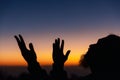 Silhouette of man kneeling down praying for worship God at sky background. Christians pray to jesus christ for calmness. In Royalty Free Stock Photo