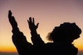 Silhouette of man kneeling down praying for worship God at sky background. Christians pray to jesus christ for calmness. In Royalty Free Stock Photo