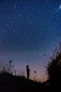 Silhouette of man looking at the infinity of stars