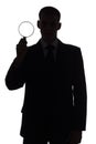 Silhouette of man with magnifying glass