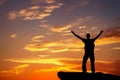 Silhouette of a man on a mountain top on fiery background Royalty Free Stock Photo