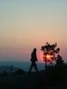 Silhouette of a man on mountain top at sunset background. Royalty Free Stock Photo