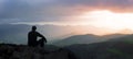 Silhouette of Man on a mountain top Sunset Background Royalty Free Stock Photo