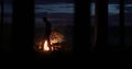 Silhouette of a man near the fire at night against the sky Royalty Free Stock Photo