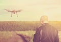 Silhouette of a man operating a drone with remote control for vi