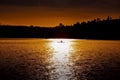 Silhouette of man paddling in kayak with dramatic sunset. Royalty Free Stock Photo