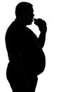 Silhouette of a man paunchy eating fast food -