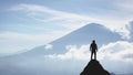 Silhouette of a man on the peak of a mountain, concept of victory and achievement Royalty Free Stock Photo