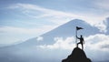 Silhouette of a man on the peak of a mountain, concept of victory and achievement Royalty Free Stock Photo