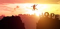 Silhouette man people jumping from cliff to other mountain with hope, concept as possible and impossible of success in business