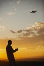 Man piloting a drone during the sunrise