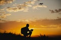 Man piloting a drone during the sunrise