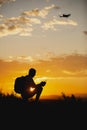 Man piloting a drone during the sunrise