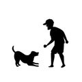 Silhouette of a man playing fetching ball game with dog