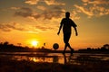 silhouette of a man playing soccer in golden hour, sunset Royalty Free Stock Photo
