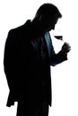 Silhouette man portrait smelling red wine glass