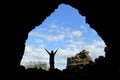 A silhouette of a man posed in front of the old church rock structure at Dimmuborgir Lava Formations, near Lake Myvatn, Iceland in