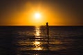 Silhouette of a man practicing stand-up paddle