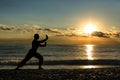 Silhouette of a man practises wing chun on the beach Royalty Free Stock Photo