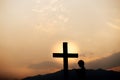 Silhouette of a man prayer in front of cross on mountain at sunset. concept of religion Royalty Free Stock Photo