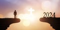 Silhouette of man praying against beautiful white cross sky background Royalty Free Stock Photo