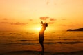 Silhouette of Man Raising His Hands or Open arms  with sunset on the beach Royalty Free Stock Photo