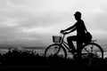 Silhouette of man riding bicycle in countryside, black and white Royalty Free Stock Photo