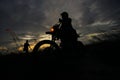 Silhouette of a man riding his motorcycle during sunset. Royalty Free Stock Photo