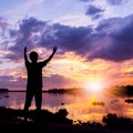 Silhouette of a man beside the river at sunset Royalty Free Stock Photo