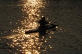 Silhouette of man rowing a kayak on the river