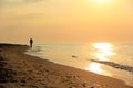 Silhouette of a man running along the seashore