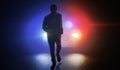 Silhouette of man running away from police car at night. Royalty Free Stock Photo