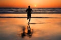 Silhouette of a man running on a beach at sunset. Royalty Free Stock Photo