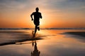 Silhouette of a man running on a beach at sunset. Royalty Free Stock Photo