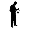 Silhouette man with saucepan spoon in his hands preparing food male cooking use sauciers black color vector illustration flat
