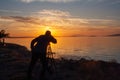 Silhouette of a man on the shore of the lake at sunset. Sunset over the sea with dramatic sky and reflection in the water Royalty Free Stock Photo