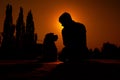 Silhouette of a man sitting with her fox terrier dog.