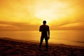 Silhouette of Man stand on the beach at Sunset Royalty Free Stock Photo