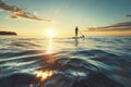 Silhouette of a Man Stand Up Paddleboarding at Sunset Royalty Free Stock Photo