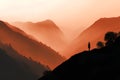 Silhouette of a man standing on a cliff in the mountains Royalty Free Stock Photo