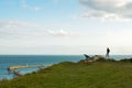 Silhouette of man standing on Dover Cliffs edge and admiring Dover Port