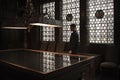 Silhouette of man standing by a grand table in an old house. Leaded windows letting in light from behind him. Royalty Free Stock Photo