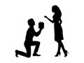 Silhouette of man standing on his knee gives gift to woman.