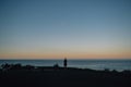 Silhouette of man standing on a lookout with sky and ocean. Alone concept Royalty Free Stock Photo