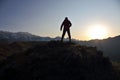 Silhouette of man standing on the mountain face to sunrise Royalty Free Stock Photo