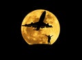 Silhouette the man standing raised up arms celebrate during airplane take off from runway with big full moon Royalty Free Stock Photo