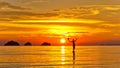 Silhouette of a man standing in the sea at sunset islands background on a tropical island Royalty Free Stock Photo