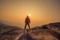 Silhouette man standing into sunset sky